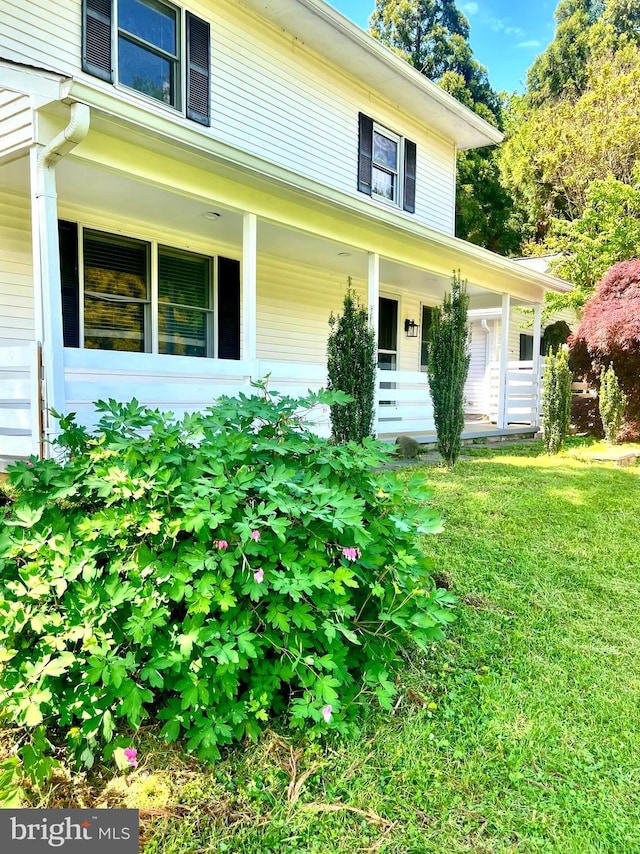 view of exterior entry with covered porch