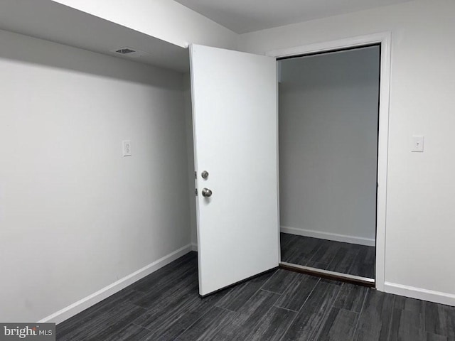 51 Healey Ct, Bunker Hill, WV 25413 - unfurnished bedroom featuring dark wood-type flooring, baseboards, and a closet
