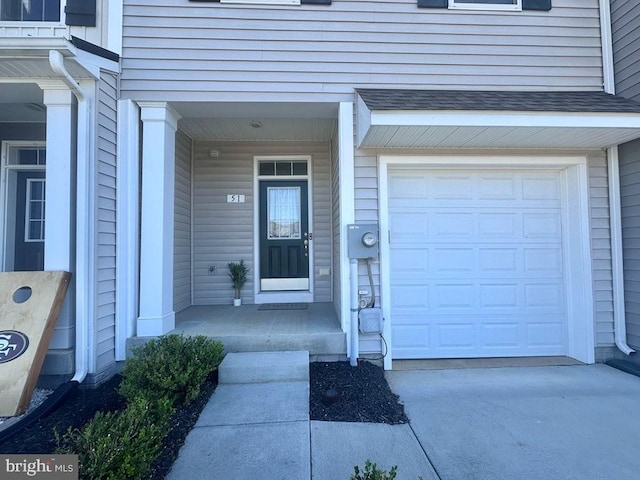 51 Healey Ct, Bunker Hill, WV 25413 - view of exterior entry featuring an attached garage, concrete driveway, and covered porch