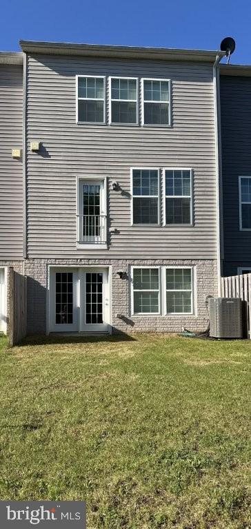 51 Healey Ct, Bunker Hill, WV 25413 - rear view of property featuring a lawn, cooling unit, and brick siding