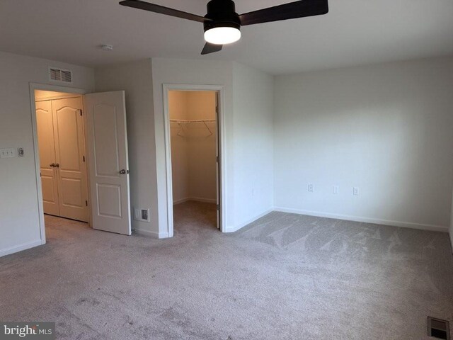 51 Healey Ct, Bunker Hill, WV 25413 - unfurnished bedroom featuring carpet flooring, a walk in closet, baseboards, and a closet