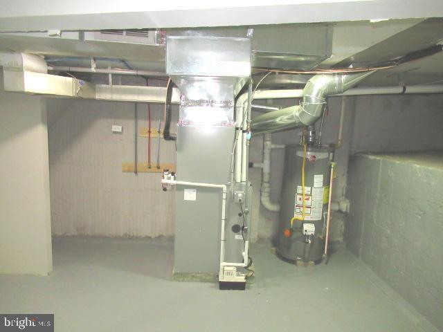 utility room with gas water heater and heating unit