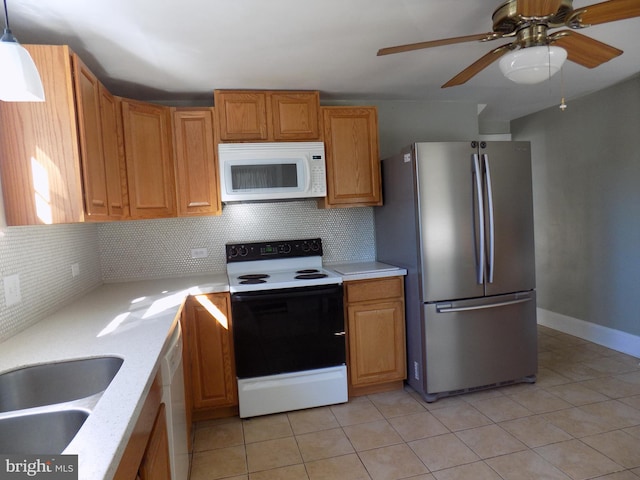 kitchen featuring white appliances, light countertops, tasteful backsplash, a ceiling fan, and light tile patterned floors