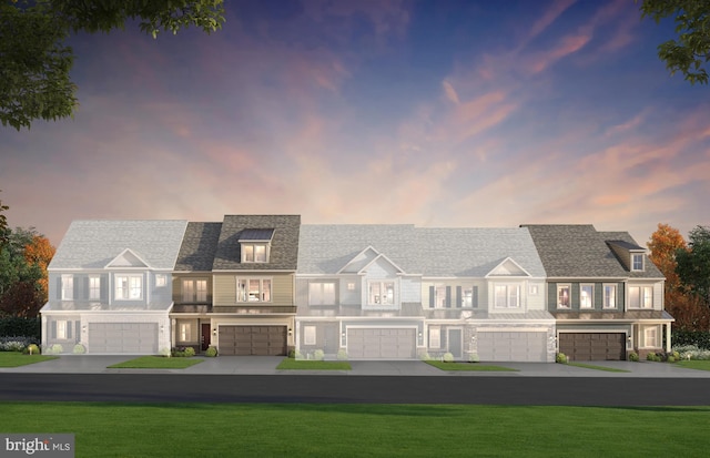 view of front of home featuring a garage, a yard, and driveway