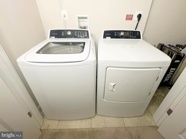11631 Dorothy Sayers Pl, White Plains, MD 20695 - laundry room with washing machine and clothes dryer and light tile patterned floors