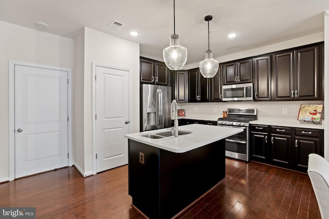 1102 Ribbon Limestone Ter SE, Leesburg, VA 20175 - kitchen with stainless steel appliances, light countertops, a sink, dark wood-type flooring, and decorative light fixtures