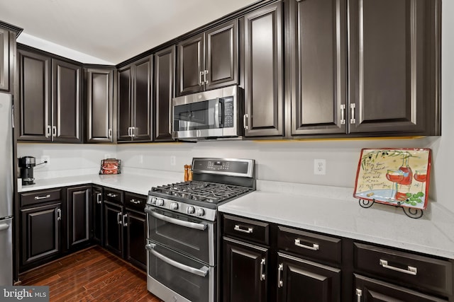 1102 Ribbon Limestone Ter SE, Leesburg, VA 20175 - kitchen featuring stainless steel appliances, dark wood-style floors, dark cabinets, and light stone counters
