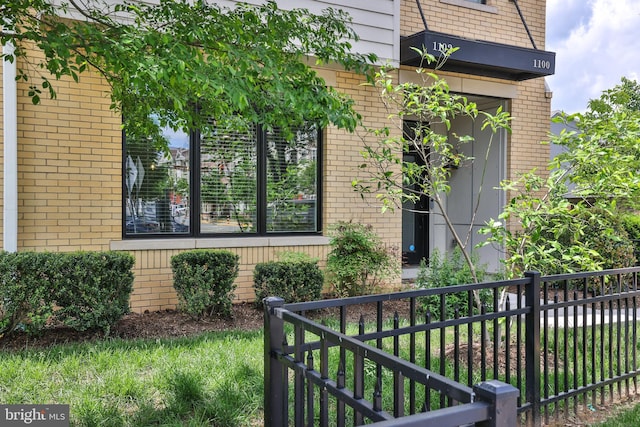 1102 Ribbon Limestone Ter SE, Leesburg, VA 20175 - view of side of home with brick siding and fence
