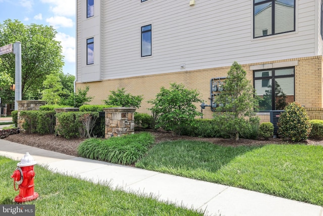 1102 Ribbon Limestone Ter SE, Leesburg, VA 20175 - view of home's exterior featuring brick siding and a lawn