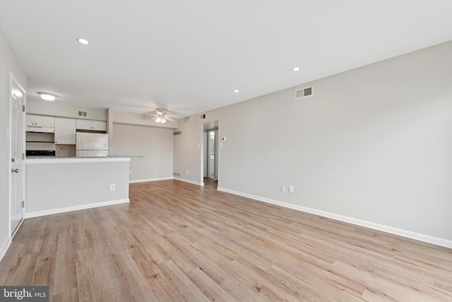 unfurnished living room featuring a ceiling fan, light wood-style flooring, baseboards, and recessed lighting