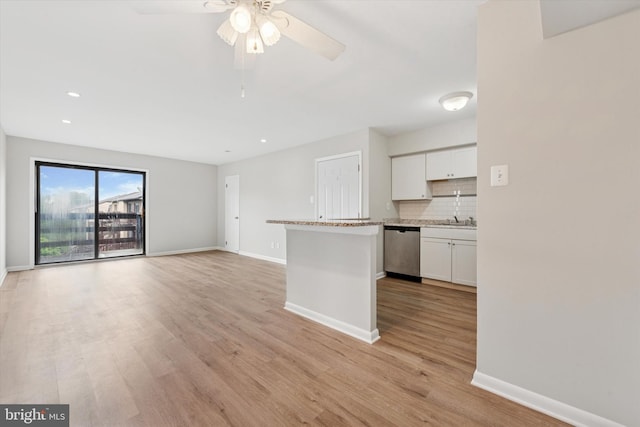 kitchen featuring stainless steel dishwasher, white cabinets, baseboards, and recessed lighting