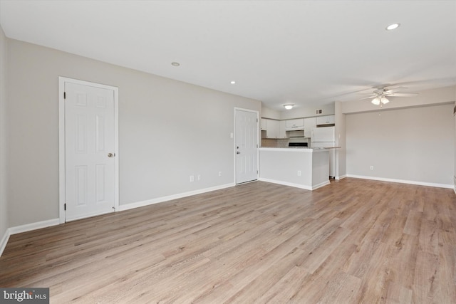 unfurnished living room featuring ceiling fan, recessed lighting, light wood finished floors, and baseboards