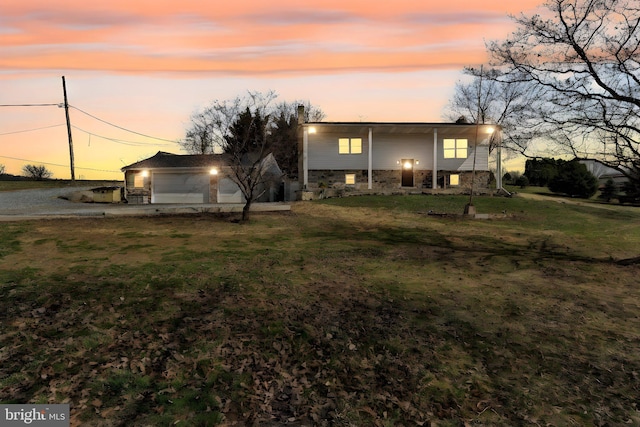 913 Pine Grove Rd, Fredericksburg, PA 17026 - back of house at dusk with a lawn and a garage
