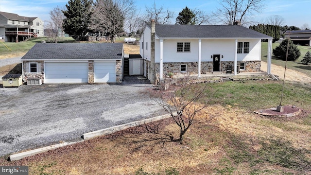 913 Pine Grove Rd, Fredericksburg, PA 17026 - view of front of property with stone siding, a chimney, driveway, and an attached garage