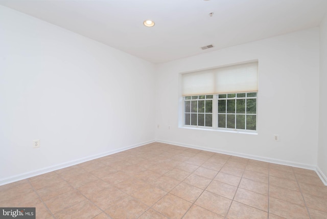 empty room with recessed lighting and baseboards