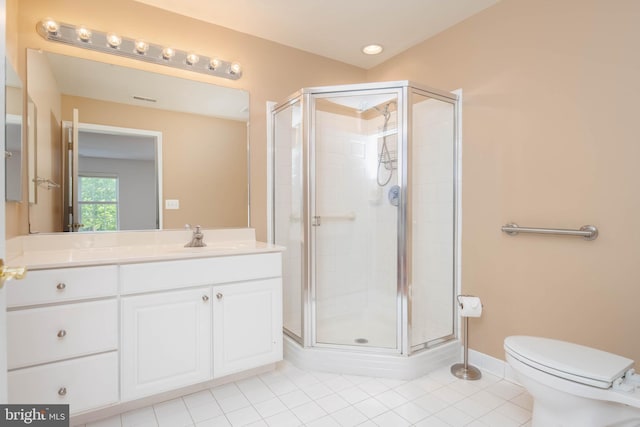 bathroom featuring tile patterned floors, a stall shower, vanity, and toilet