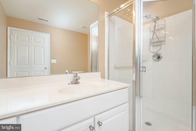 full bath with a shower stall and vanity