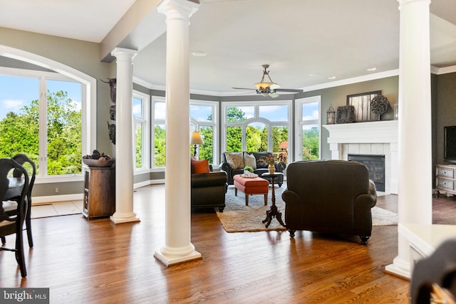 20550 Wildbrook Ct, Ashburn, VA 20147 - living area featuring ceiling fan, crown molding, a fireplace, decorative columns, and wood finished floors