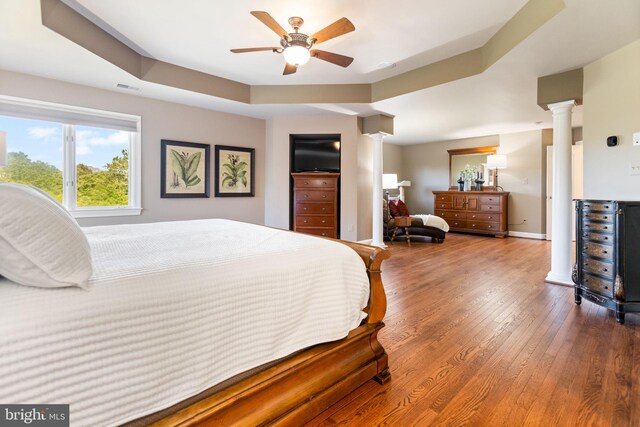 20550 Wildbrook Ct, Ashburn, VA 20147 - bedroom with ornate columns, wood finished floors, a ceiling fan, and baseboards