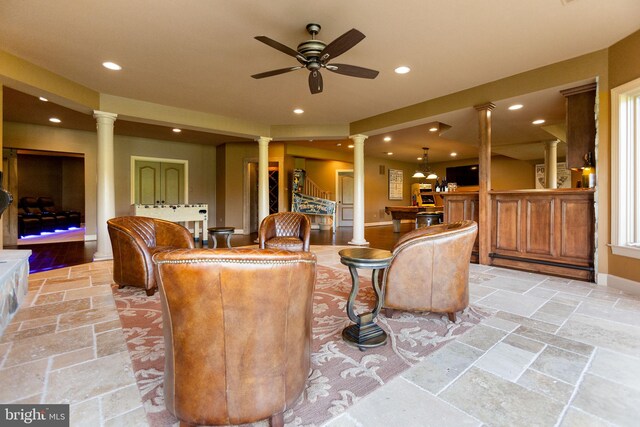 20550 Wildbrook Ct, Ashburn, VA 20147 - living area with ornate columns, recessed lighting, stone tile floors, bar, and ceiling fan
