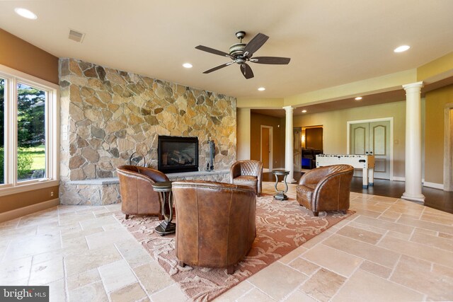 20550 Wildbrook Ct, Ashburn, VA 20147 - living area with decorative columns, stone tile flooring, a ceiling fan, recessed lighting, and a stone fireplace