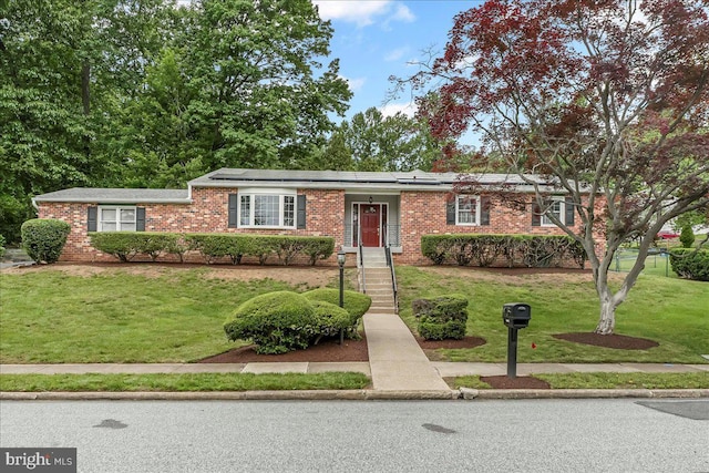 1795 Hillcrest Ln, Aston, PA 19014 - ranch-style house with a front lawn, brick siding, and solar panels