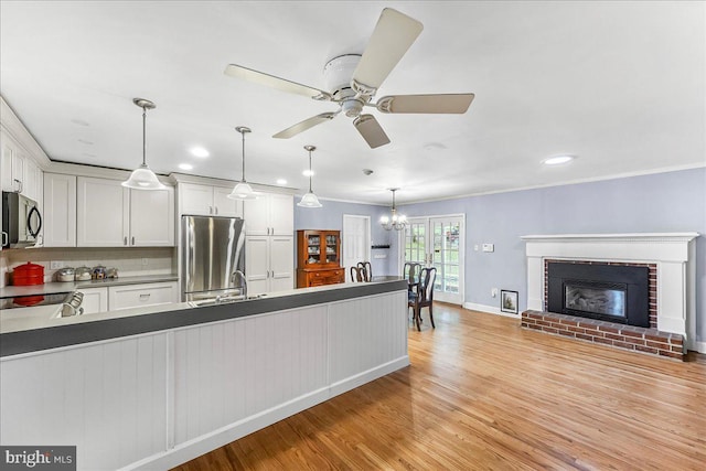1795 Hillcrest Ln, Aston, PA 19014 - kitchen featuring appliances with stainless steel finishes, ceiling fan, light wood-style flooring, a chandelier, and white cabinets