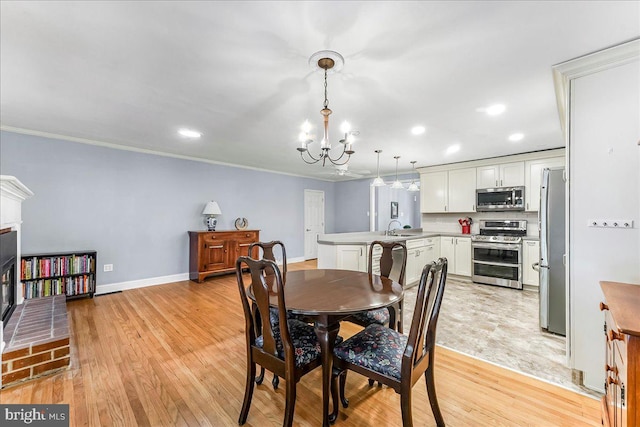 1795 Hillcrest Ln, Aston, PA 19014 - dining space featuring a chandelier, recessed lighting, light wood-type flooring, crown molding, and baseboards