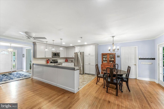 1795 Hillcrest Ln, Aston, PA 19014 - kitchen with a chandelier, appliances with stainless steel finishes, light wood-type flooring, baseboards, and crown molding