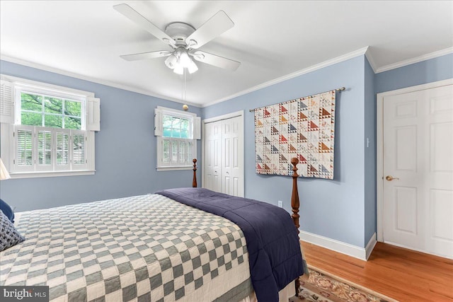 1795 Hillcrest Ln, Aston, PA 19014 - bedroom featuring wood finished floors, multiple windows, a closet, baseboards, and crown molding