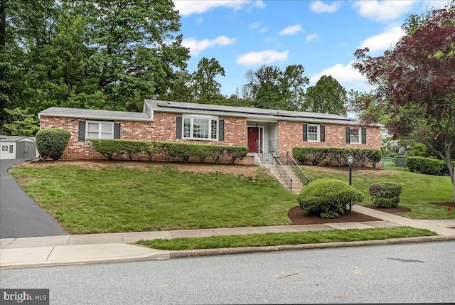 1795 Hillcrest Ln, Aston, PA 19014 - ranch-style house with a front yard, brick siding, and roof mounted solar panels