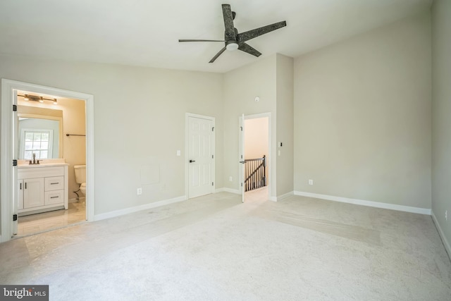 5561 Jowett Ct, Alexandria, VA 22315 - unfurnished bedroom featuring light carpet, lofted ceiling, and connected bathroom