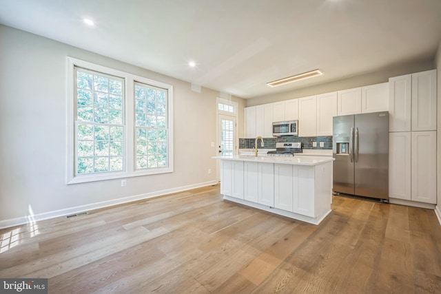 5561 Jowett Ct, Alexandria, VA 22315 - kitchen featuring appliances with stainless steel finishes, light countertops, tasteful backsplash, light wood-style flooring, and recessed lighting