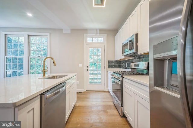 5561 Jowett Ct, Alexandria, VA 22315 - kitchen with stainless steel appliances, light wood-type flooring, tasteful backsplash, and white cabinetry