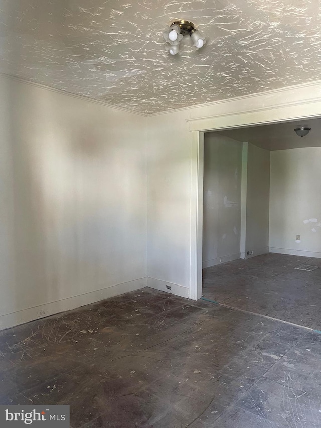 unfurnished room featuring baseboards