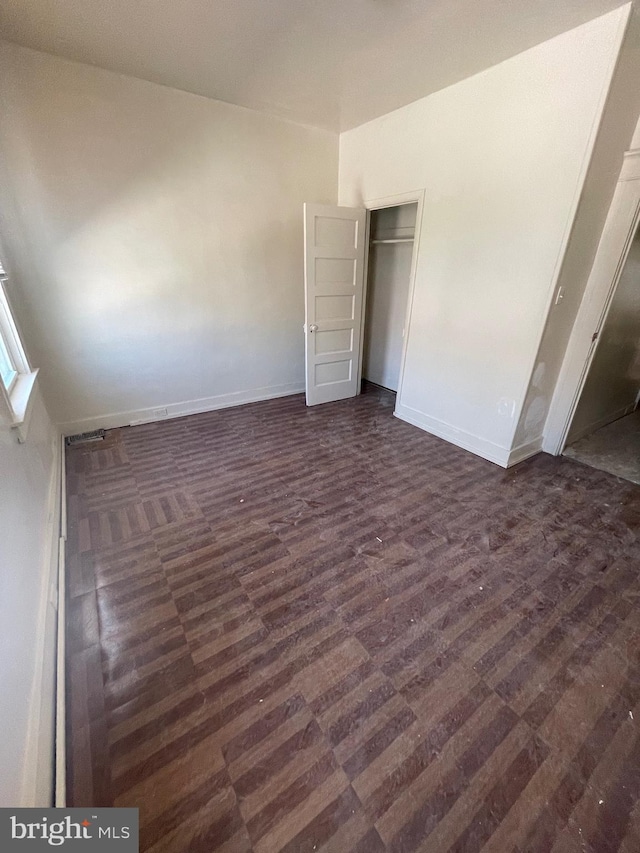 unfurnished bedroom featuring baseboards and a closet