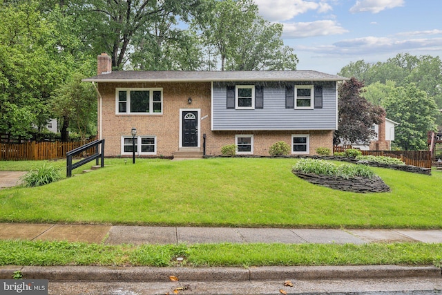 12991 Orleans St, Woodbridge, VA 22192 - split foyer home featuring entry steps, a chimney, and brick siding