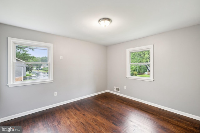 12991 Orleans St, Woodbridge, VA 22192 - unfurnished room with plenty of natural light, baseboards, and dark wood-style flooring