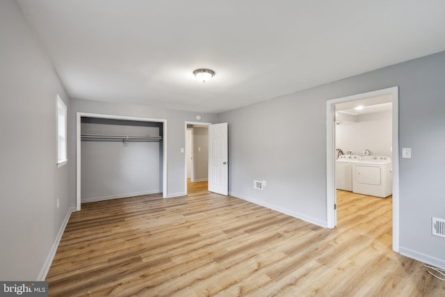 12991 Orleans St, Woodbridge, VA 22192 - unfurnished bedroom featuring washer and dryer, wood finished floors, and baseboards