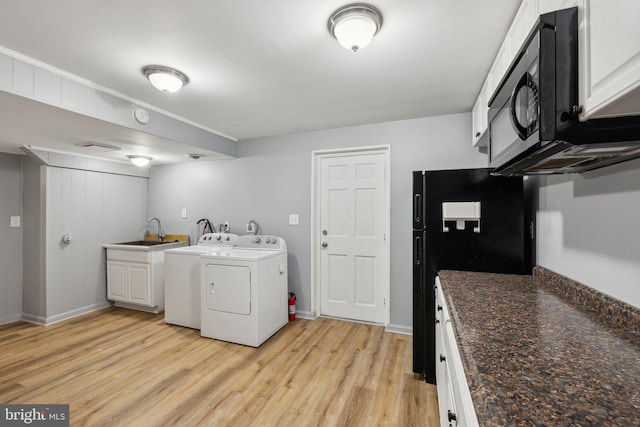 12991 Orleans St, Woodbridge, VA 22192 - laundry room with washer and clothes dryer, a sink, light wood-style floors, and baseboards
