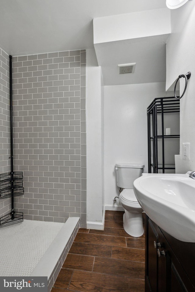 12991 Orleans St, Woodbridge, VA 22192 - full bath with wood finished floors, a stall shower, toilet, and vanity