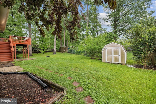 12991 Orleans St, Woodbridge, VA 22192 - view of yard with stairs, a wooden deck, a storage unit, and an outbuilding