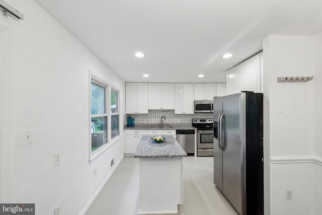 12991 Orleans St, Woodbridge, VA 22192 - kitchen featuring stainless steel appliances, white cabinets, a sink, recessed lighting, and light stone countertops