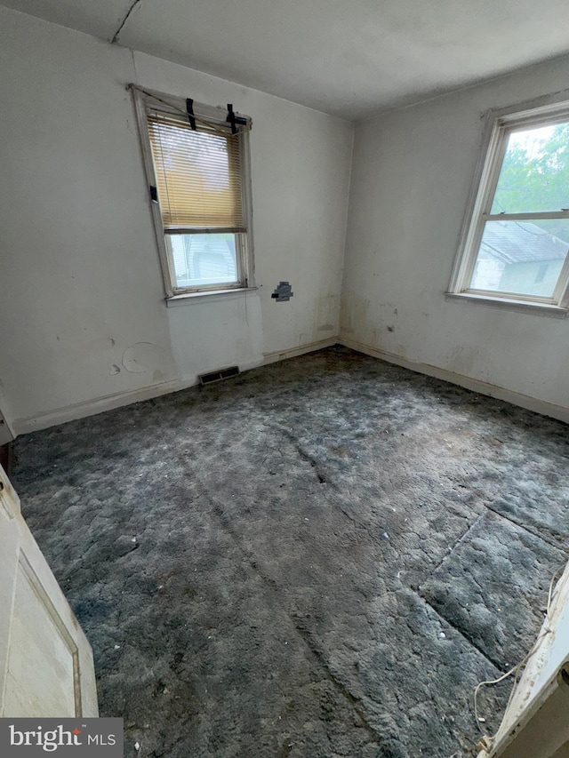 unfurnished room with healthy amount of natural light