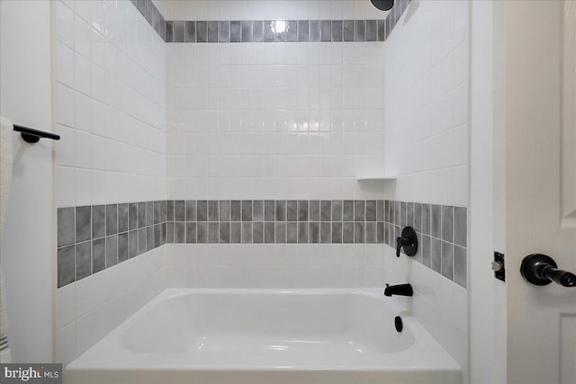 bathroom with a tub to relax in and a shower