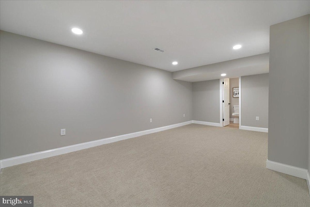 finished basement with baseboards, recessed lighting, and light carpet