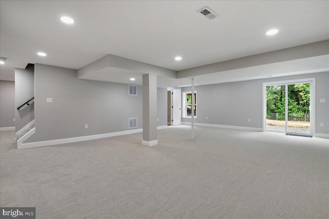 basement with baseboards, light carpet, and recessed lighting