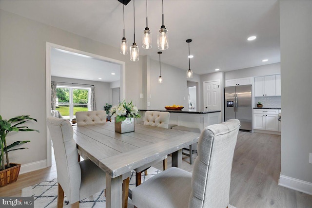 dining area with light wood-style flooring, baseboards, and recessed lighting