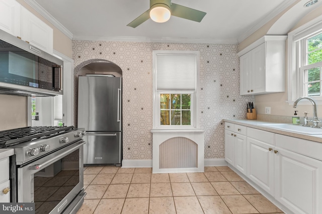 119 Burke, Towson, MD 21286 - kitchen with stainless steel appliances, a sink, white cabinets, ceiling fan, and ornamental molding