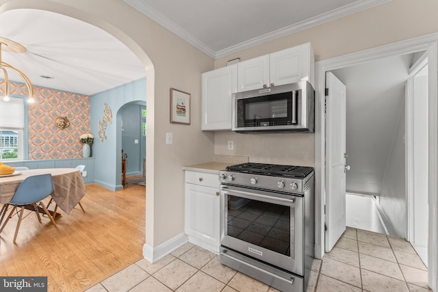 119 Burke, Towson, MD 21286 - kitchen featuring stainless steel appliances, white cabinetry, crown molding, arched walkways, and baseboards